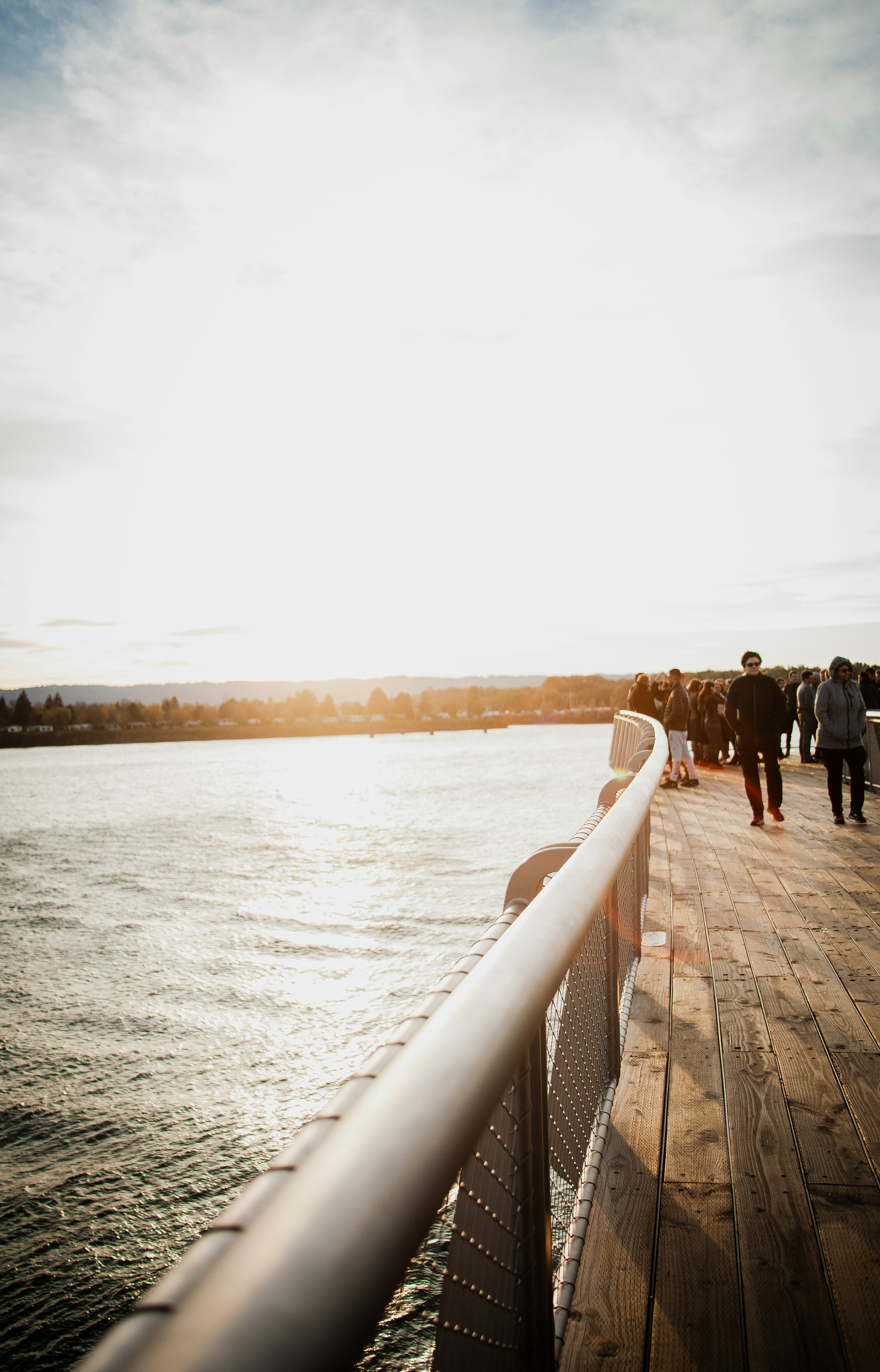 people standing and walking on dock during day